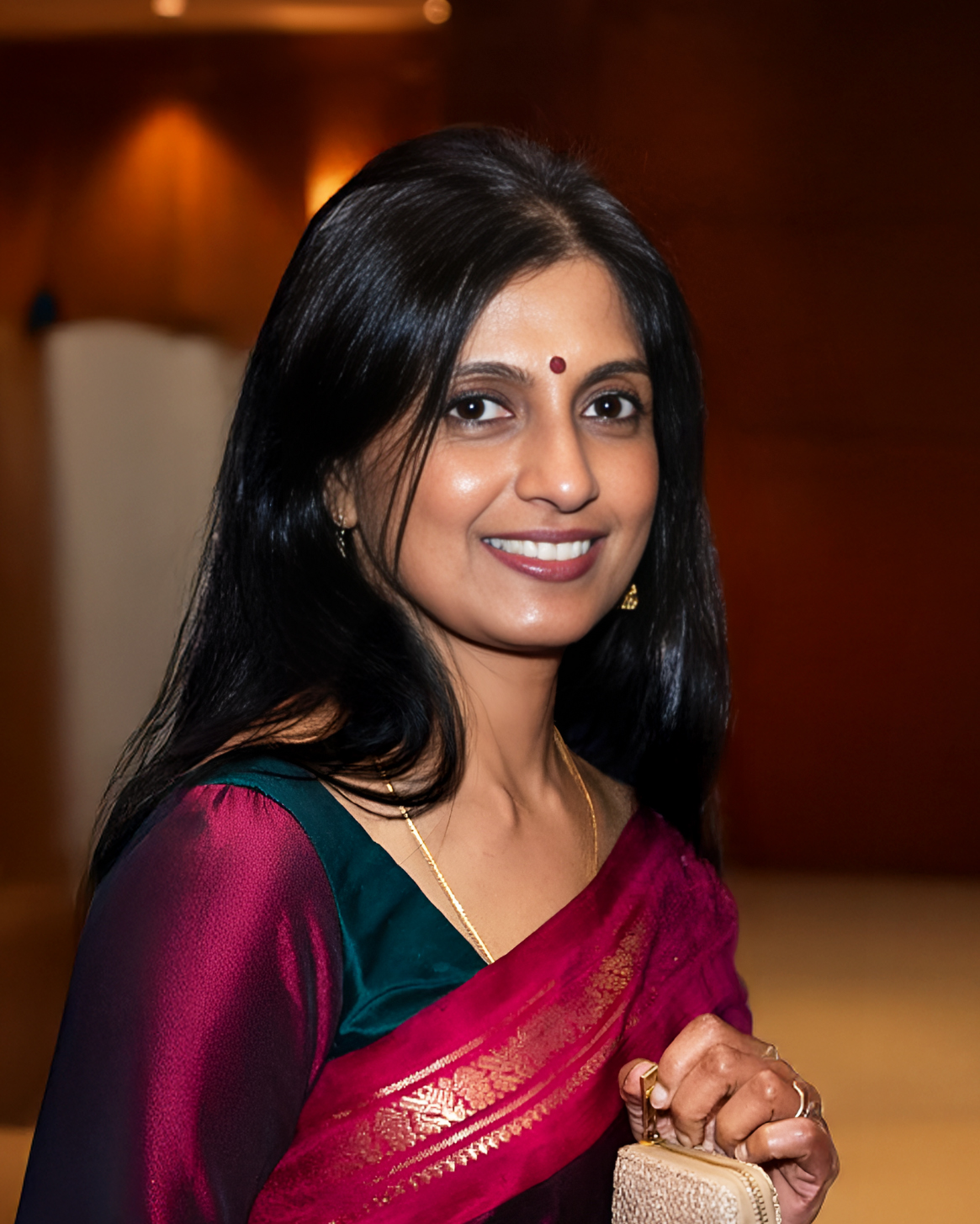 Portrait of Sumethirai Nandhakumaran smiling in sari